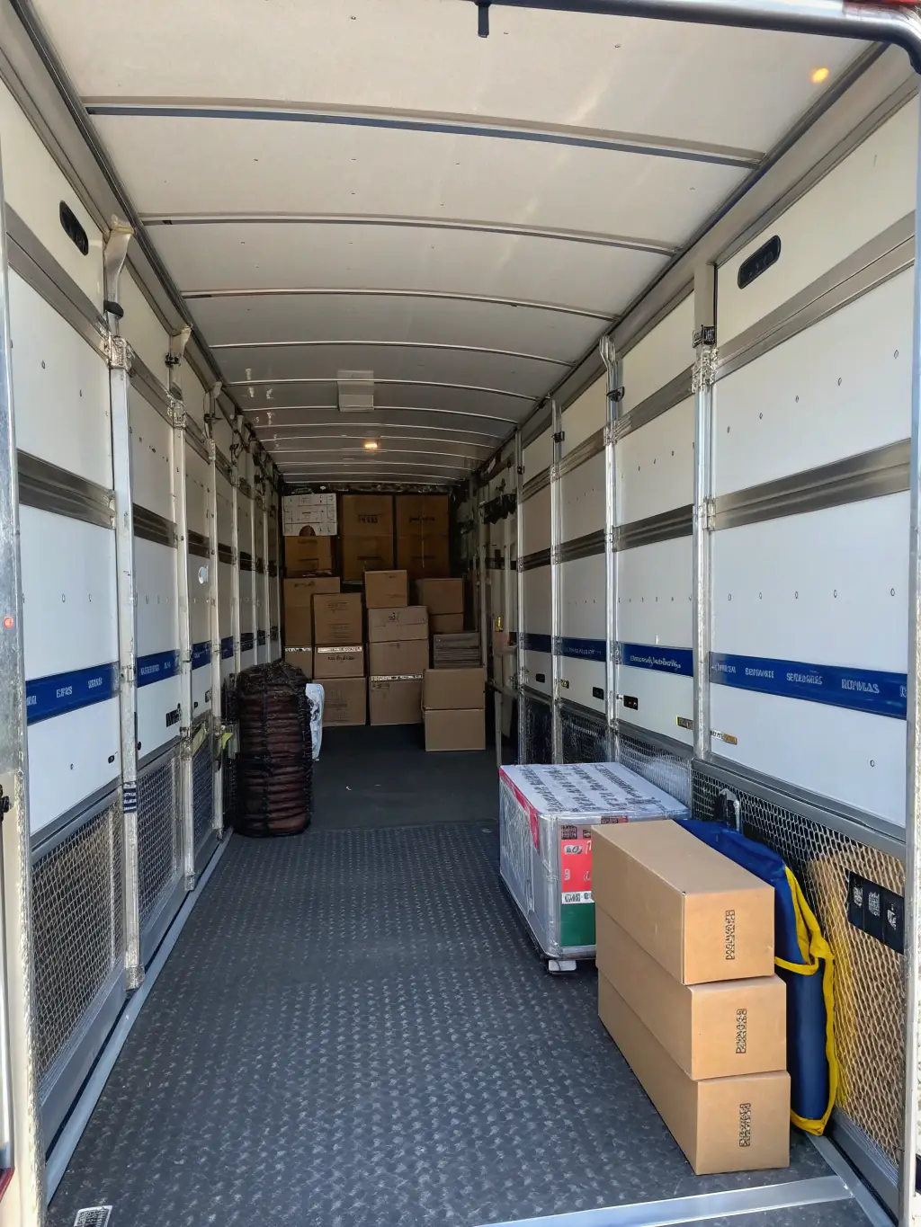 A secure, climate-controlled moving truck interior, showcasing delicate restaurant equipment and fragile retail displays safely secured for transport, emphasizing safety and security.